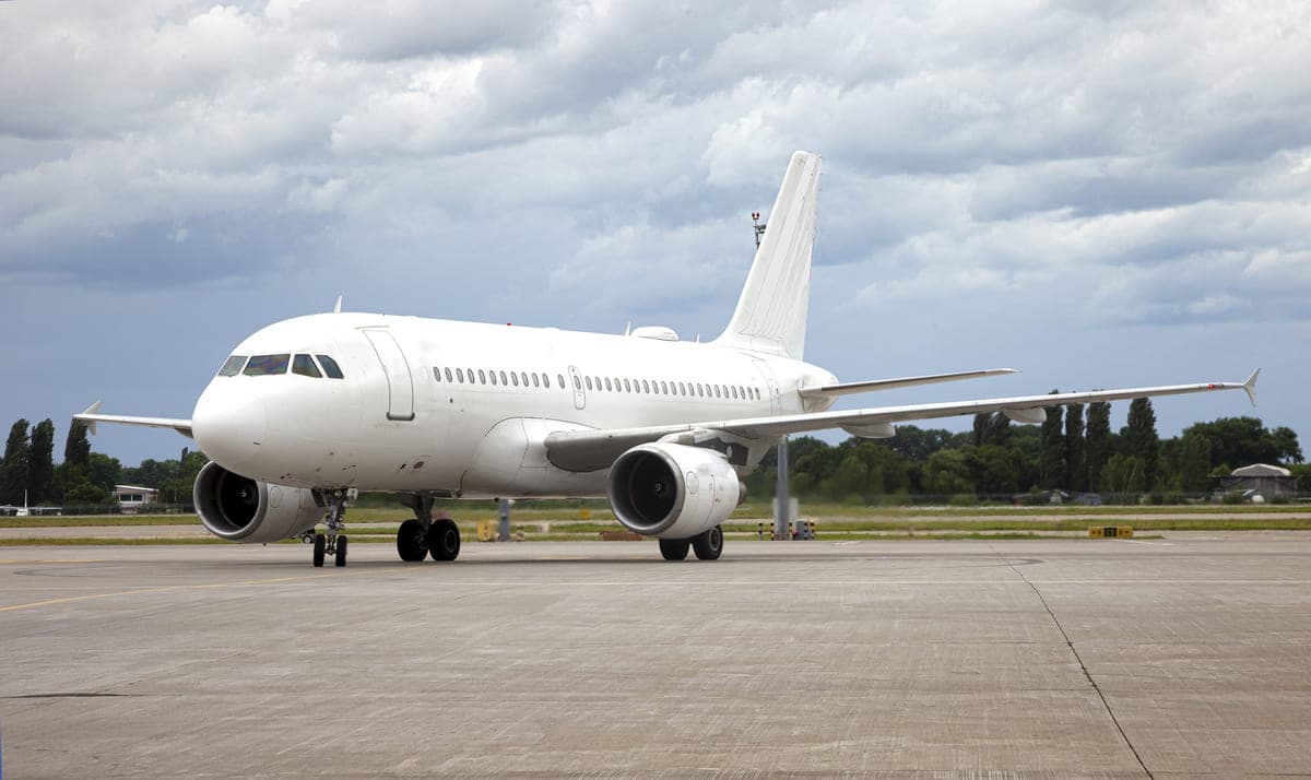 White passenger jet on an airport apron